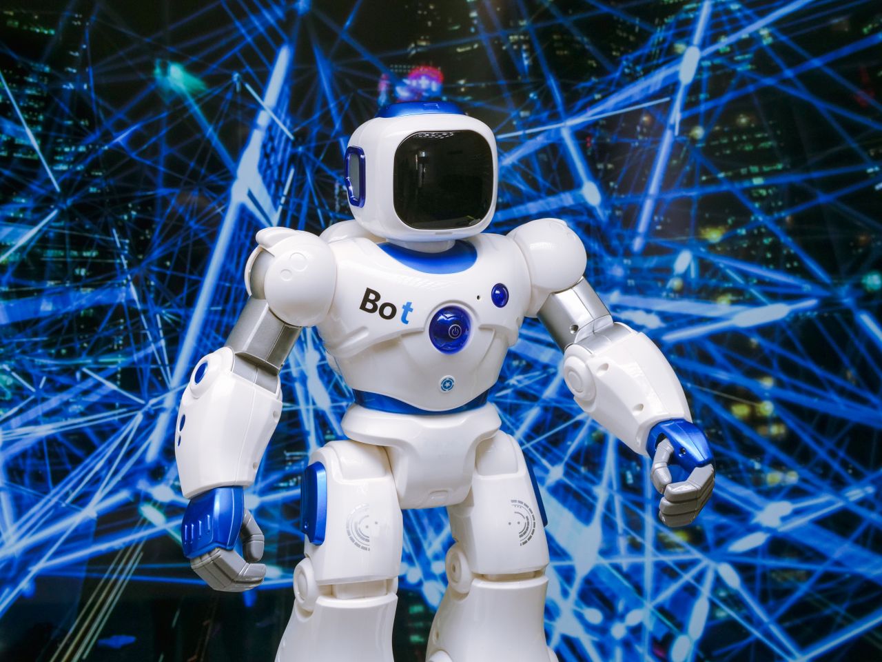 services-02 Advanced humanoid robot with glowing blue accents in a digital network setting.